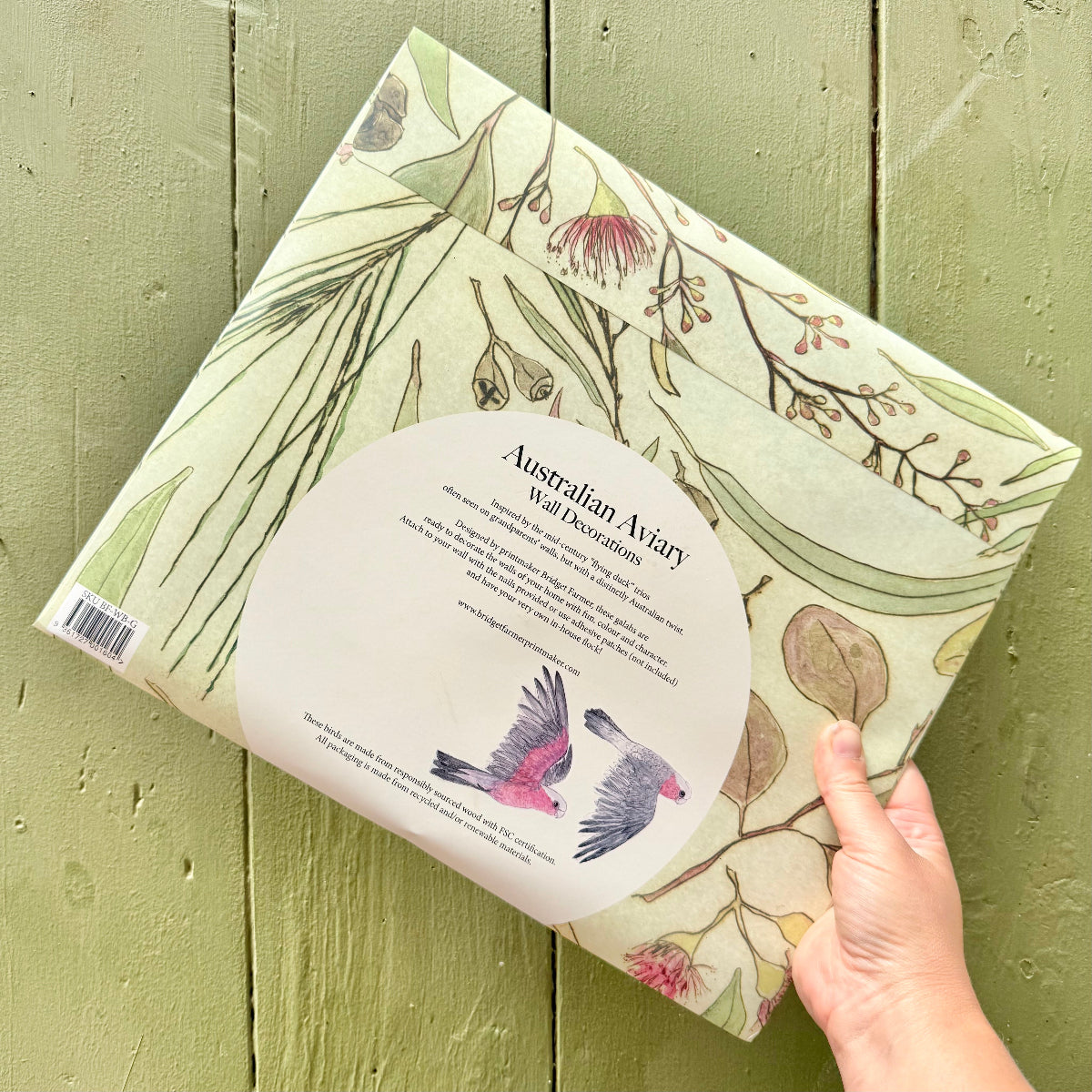 Packaging of Australian Aviary wall decorations on a wooden surface